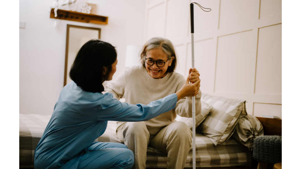A nurse assists a patient in acute hospital rehab setting
