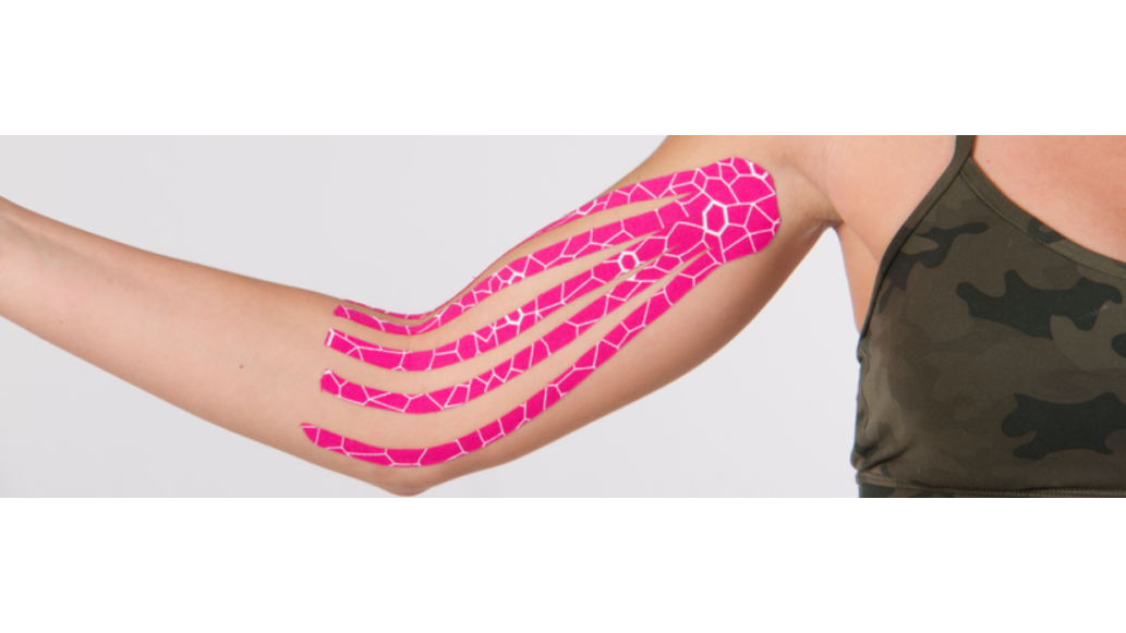 Pink Kinesiology tape in fan cut on a woman's arm