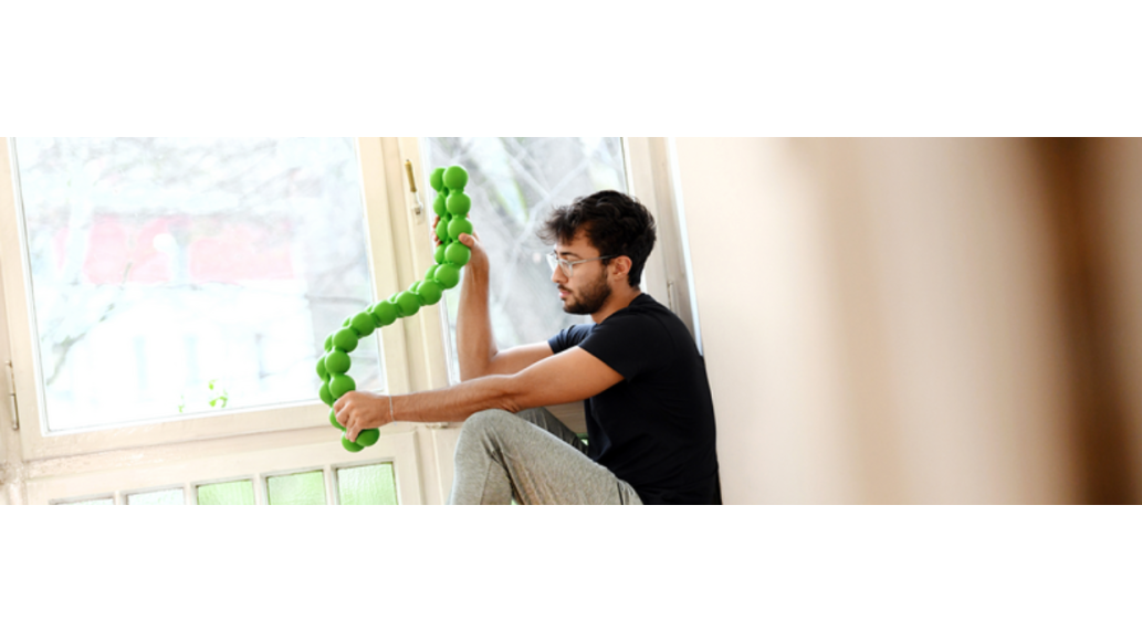 Man sits win windowsill with a SPINEFITTE twisting in his hands.R