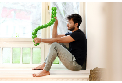 Man sits win windowsill with a SPINEFITTE twisting in his hands.R