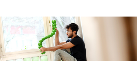 Man sits win windowsill with a SPINEFITTE twisting in his hands.R