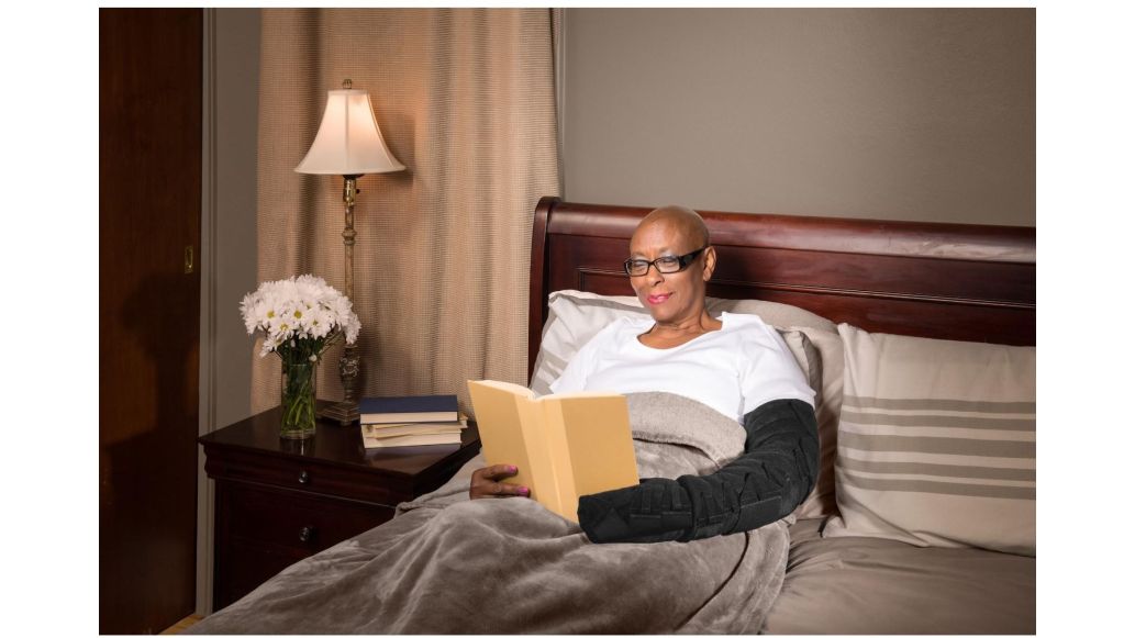 woman with an arm wrap laying in bed